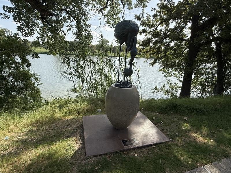 Bronze flamingo mother and chick with an enormous egg on the Waco Sculpture Zoo trail