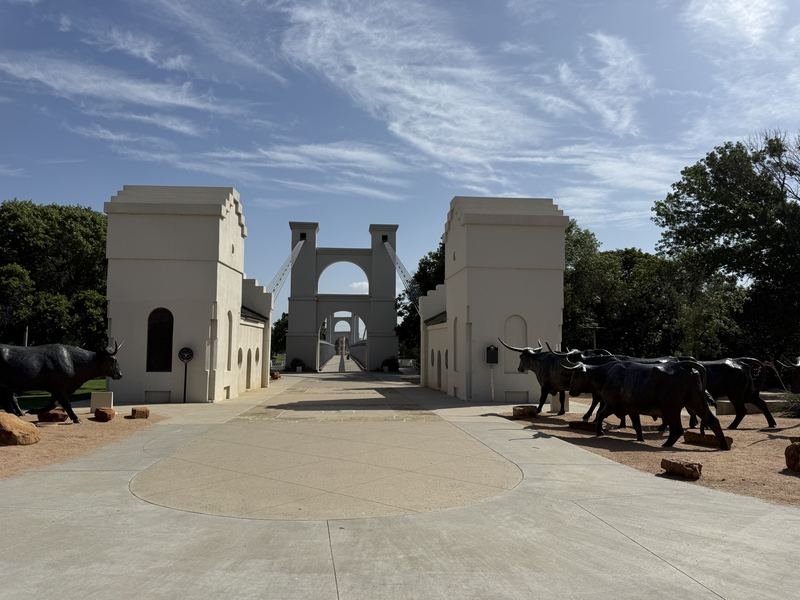 The Waco Suspension Bridge in morning light over the Brazos River, the starting point of the free Sculpture Zoo trail