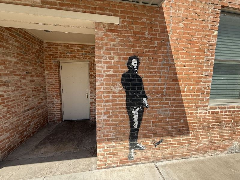Blek le Rat's Chopin stencil on the side wall of Waco Running Company in downtown Waco, Texas