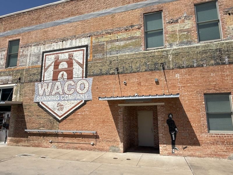 The full brick wall at Waco Running Company with Blek le Rat's Chopin stencil, downtown Waco