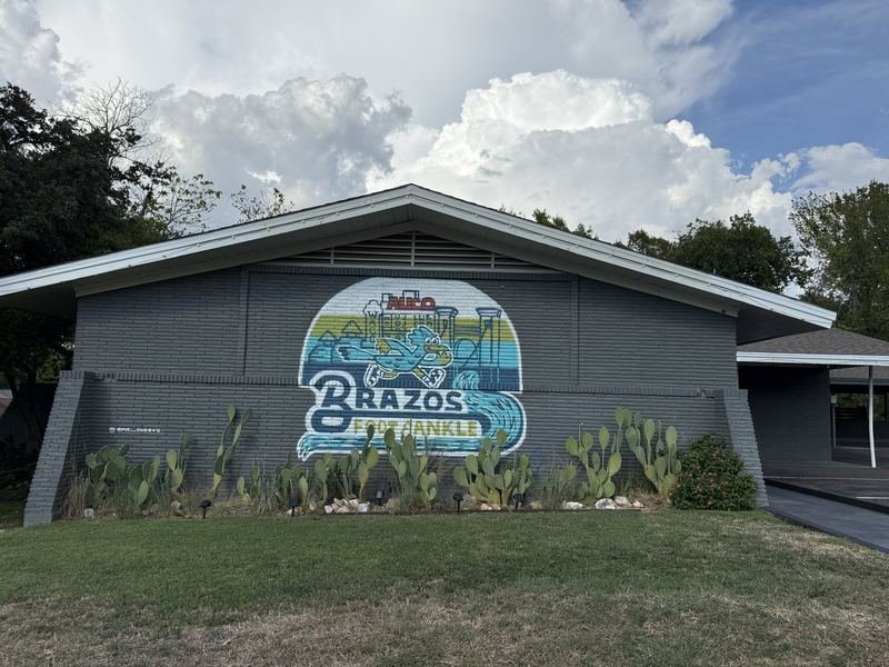A Foot That Loves the Brazos — Closer — the mascot and the skyline