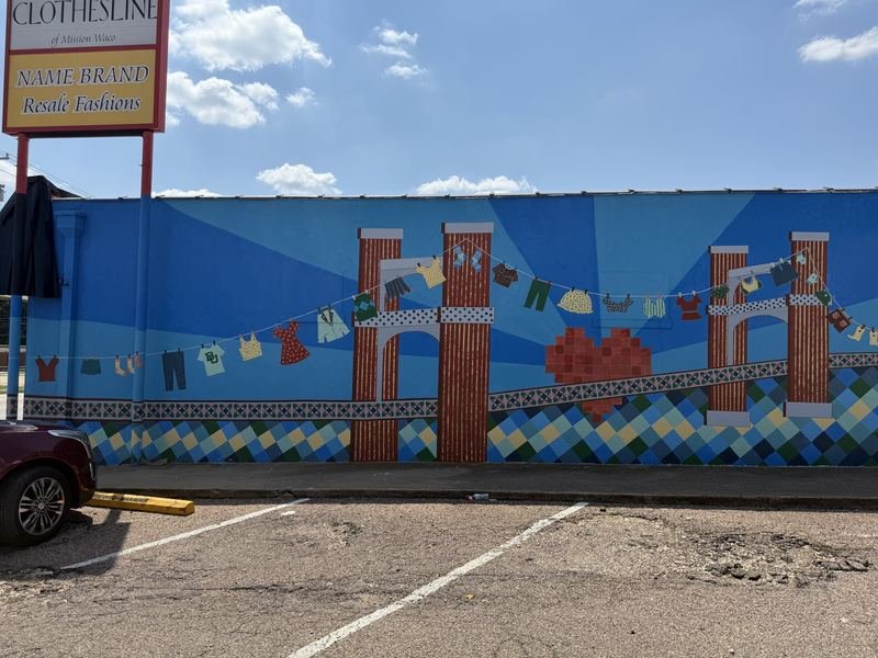 The Bridge Held Up by Laundry — The full wall from across the lot