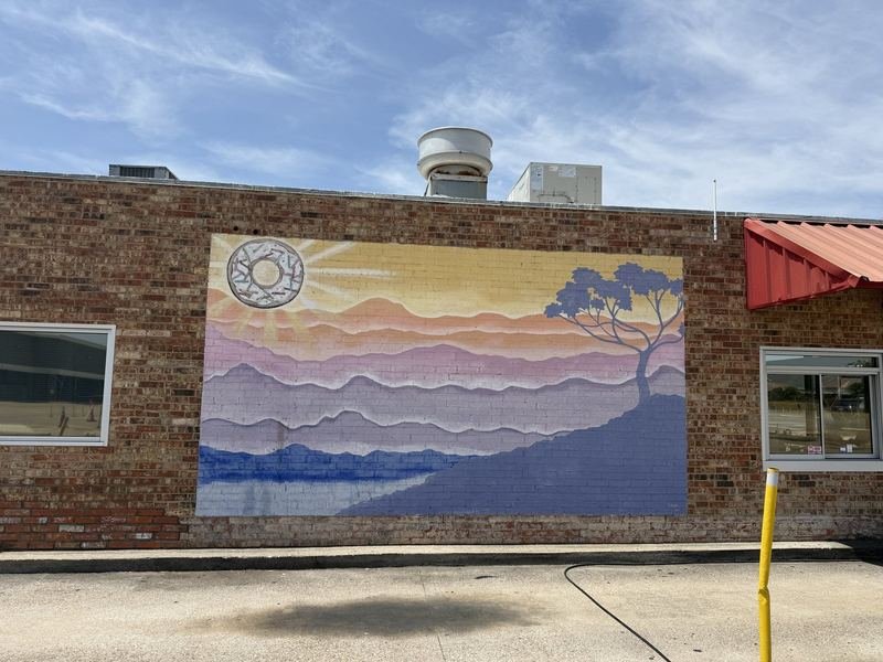 The Sun Came Up a Doughnut — On the side of the shop, beside the drive-through