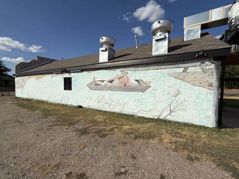The Long Table on Taylor Street — The man in the flat-bottomed boat, one foot up