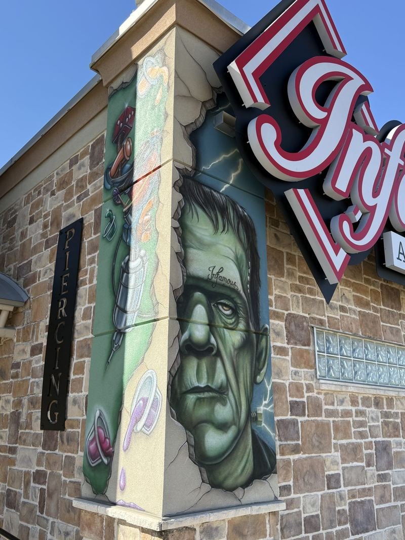 The Building With Tattoos — The monster, next to the PIERCING sign