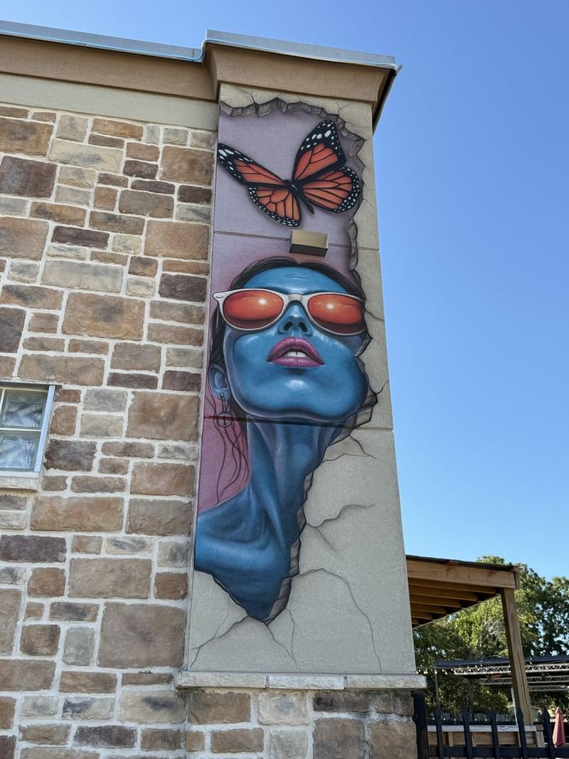 The Building With Tattoos — The lady in the sun, butterfly inbound