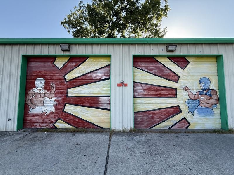 The Doors Come Out Swinging — Painted bay doors, Waco, Texas
