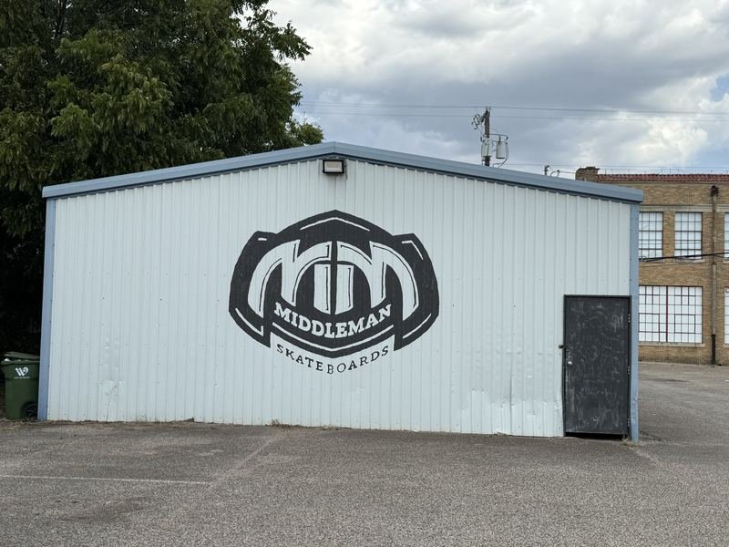 The Middleman Mark — Middleman Skateboards logo wall, Waco, Texas