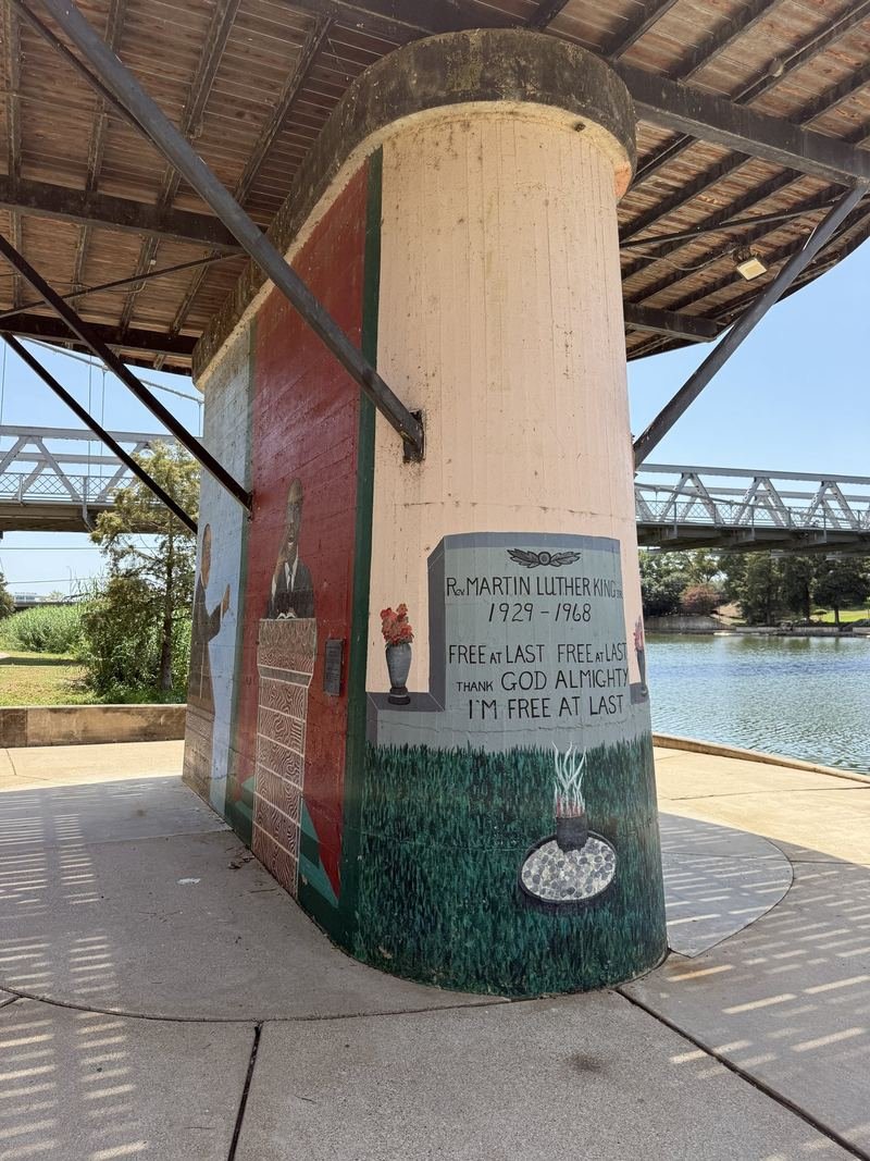 The Dream, Painted on a Bridge Pier โ The river, and the old truss bridge beyond