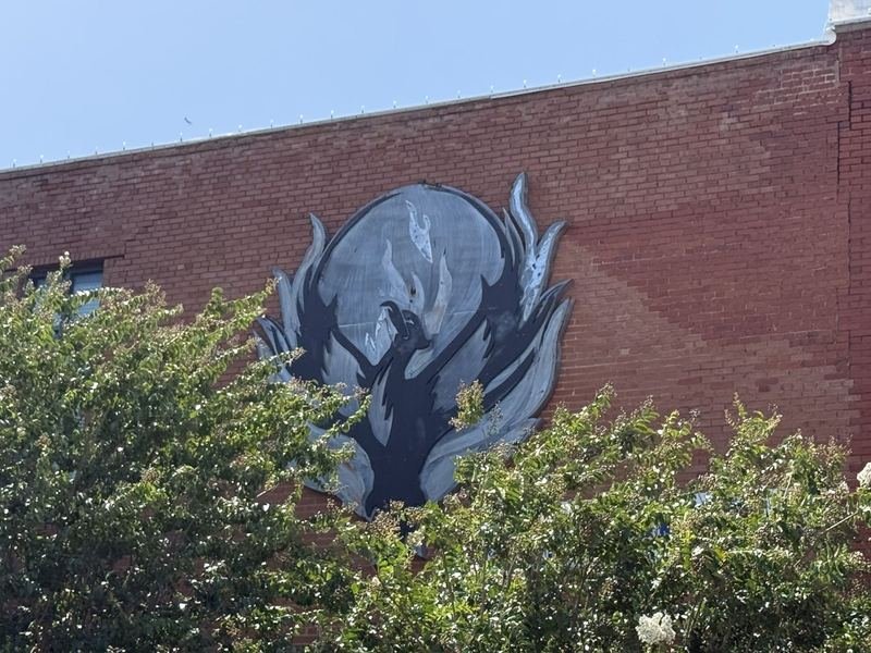 The Building That Rose From Its Ashes — The steel phoenix over the door
