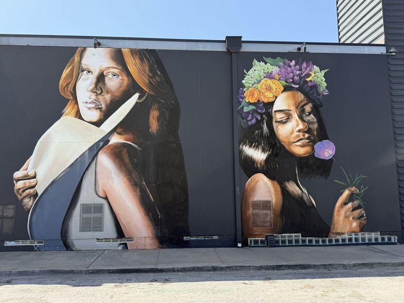 Wildflowers II mural portraits of two Waco teens on the shipping-container walls of Hotel Herringbone