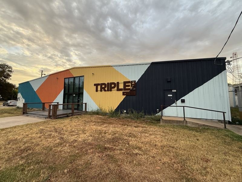 Reaching Beyond — The front wall and the Triple Win Waco sign