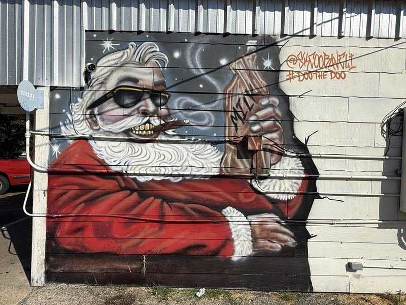 The Ice Box — Around the side: Santa, sunglasses, cigar, milk