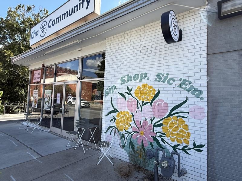 Sip. Shop. Sic ’Em. — The corner, with the round Cha Community sign