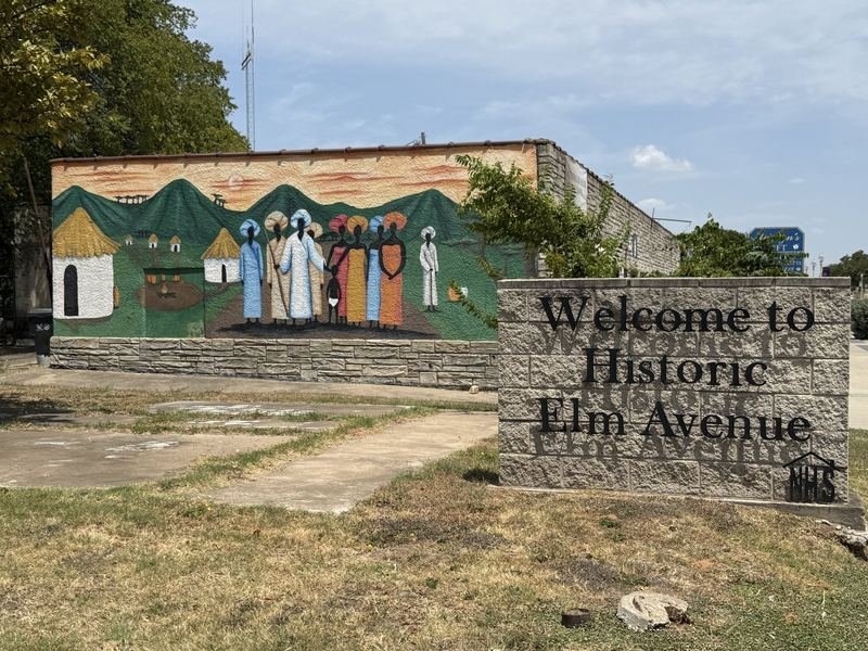 The Village at the Top of the Avenue — And the marker standing beside it