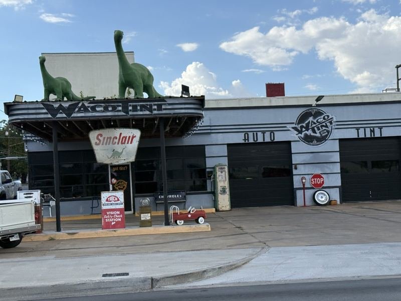Two Dinosaurs on a Tint Shop Roof — The dinosaurs on the roof