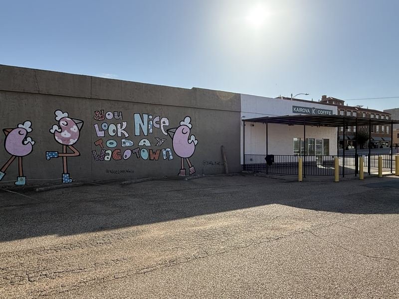 The Wall That Compliments You — Doing its work over an ordinary parking lot