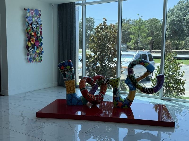 The Dancers Who Never Come Down — Inside the lobby: LOVE, and a wall of balloons
