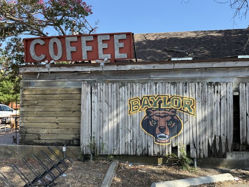 The Bear on the Fence — hand-painted sign in Waco, Texas