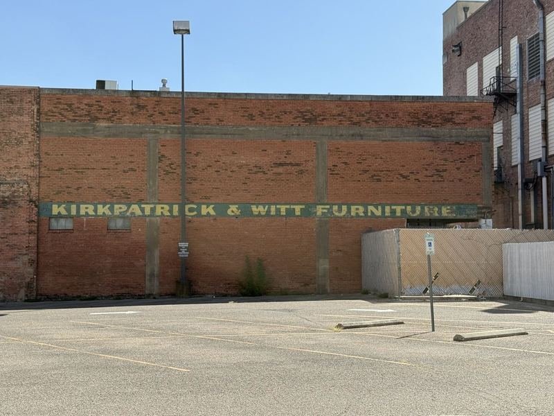 Hand-painted Kirkpatrick and Witt furniture sign on a brick wall in downtown Waco
